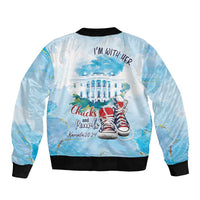 Unisex light-blue bomber jacket with ribbed collar, I’m with her back text and sneakers