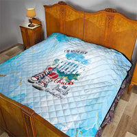 Light blue quilt with diamond stitching on bed, sneaker graphic and “Chucks and Pearls” logo