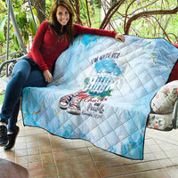 Light blue quilt draped on couch, diamond stitching with sneaker graphic and “Chucks and Pearls” text
