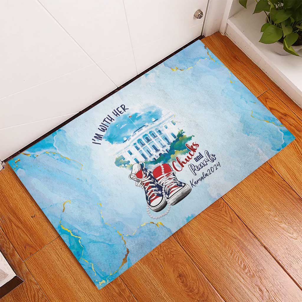 Light blue rubber doormat with sneaker design and 'I'm With Her' print near door