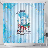 Blue shower curtain on top rod with grommets; I'm with her text, sneakers and building