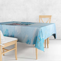 Light blue tablecloth with printed city artwork and painterly blue streaks