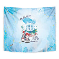Close view of blue tapestry with "I'm With Her" text, White House and red sneakers
