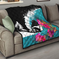 Folding sofa quilt with black splash scene, teal ocean tones, and pink tropical flower print.