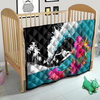 Kids crib quilt in black and teal with surfing graphic, white waves, and pink hibiscus flowers.