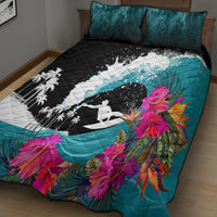 Teal quilt with black-and-white surf rider print and bright pink floral accents; two pillows