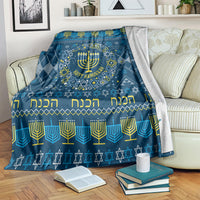 Blue Hanukkah blanket over couch with menorah wreath, 'Happy Hanukkah' and Hebrew text
