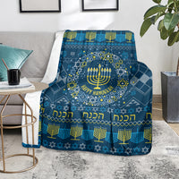 Blue Hanukkah blanket on armchair with menorah wreath and 'Happy Hanukkah' lettering