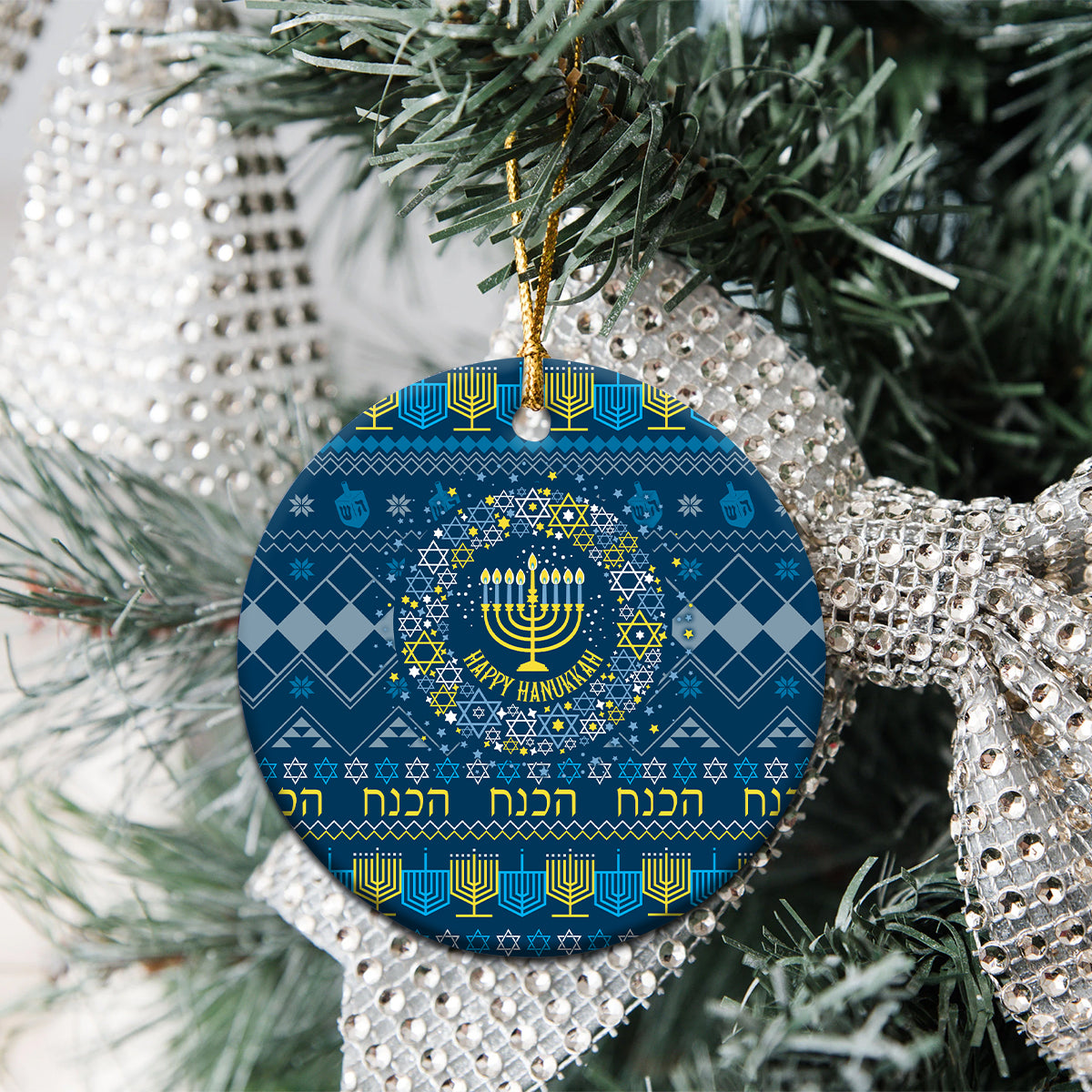 Blue round ceramic Hanukkah ornament with menorah pattern and gold hanging loop.