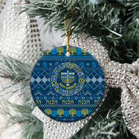 Blue round ceramic Hanukkah ornament with menorah pattern and gold hanging loop.