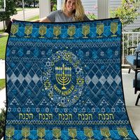 Blue Hanukkah quilt with central menorah in a star wreath and yellow decorative text