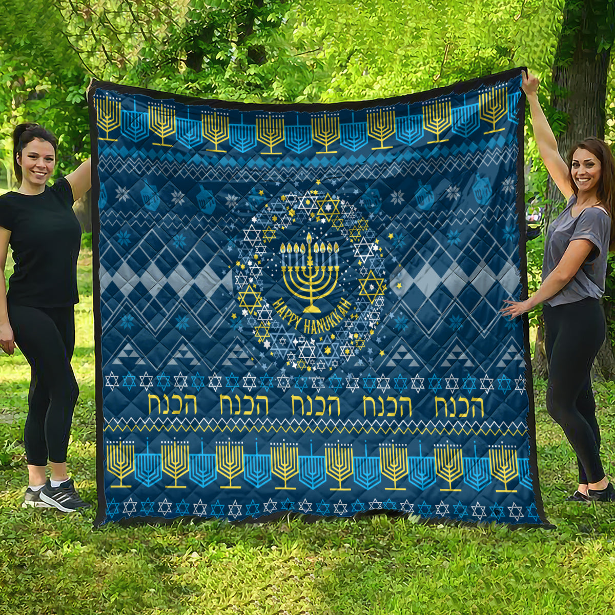 Blue Hanukkah quilt with central menorah, geometric star border, and yellow lettering