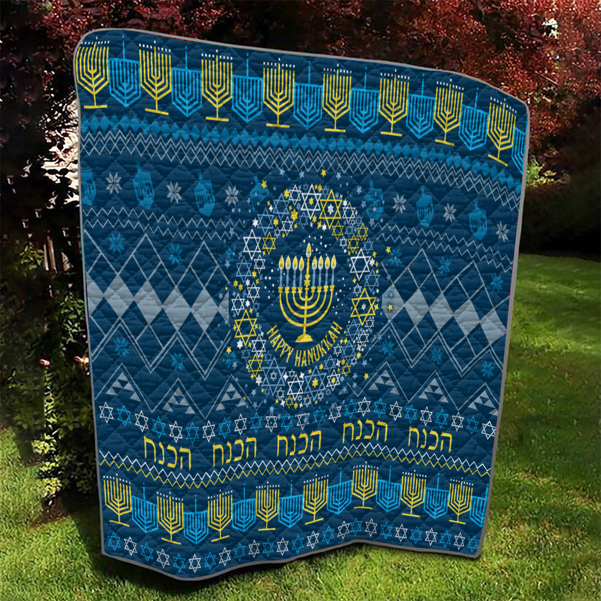 Blue Hanukkah quilt with menorah medallion, patterned diamonds, and yellow trim