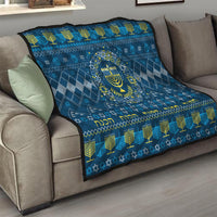 Blue Hanukkah quilt on sofa with menorah star emblem, zigzag border, and yellow accents