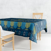Blue patterned Hanukkah tablecloth draped over rectangular table