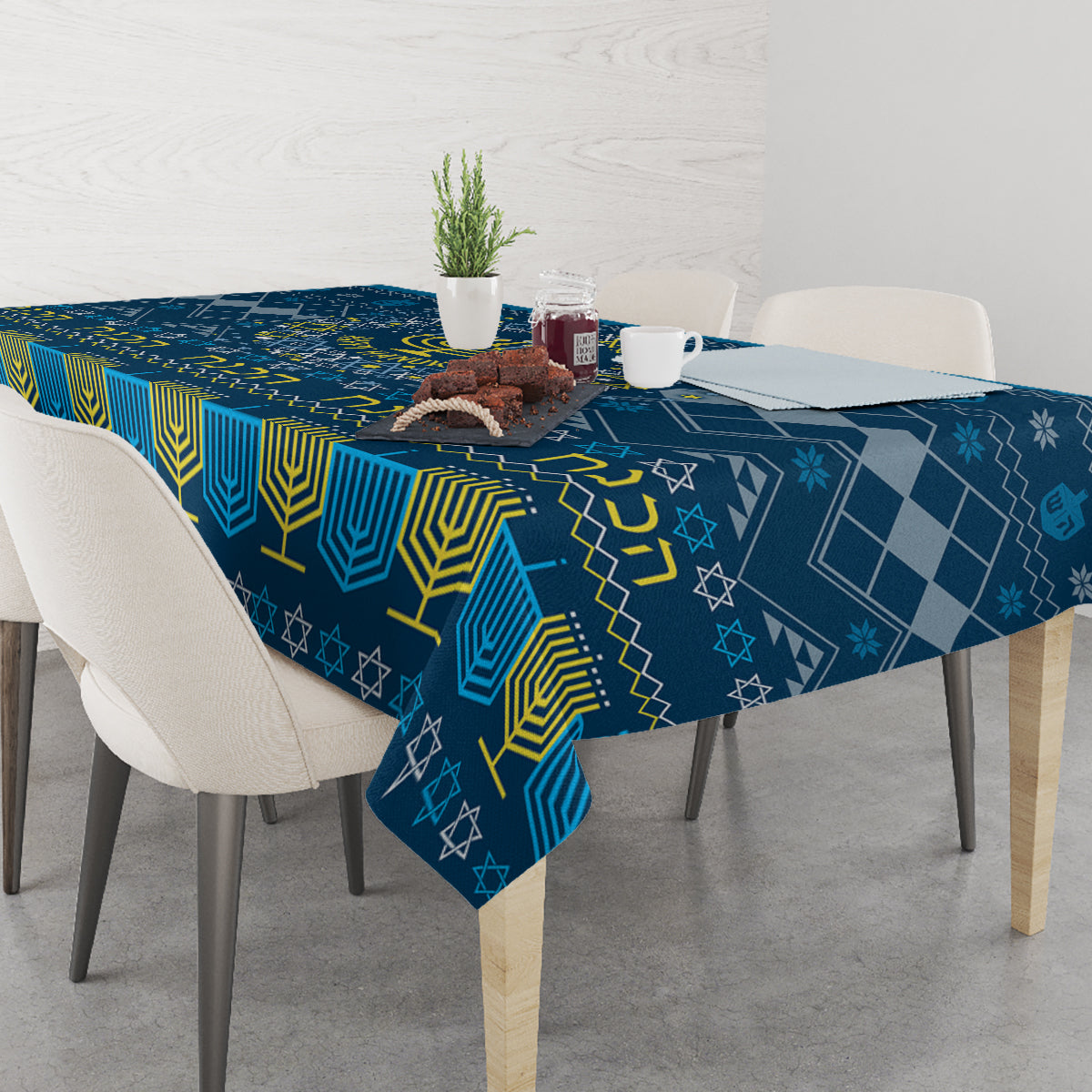 Blue Hanukkah tablecloth with menorah and star motifs on dining table