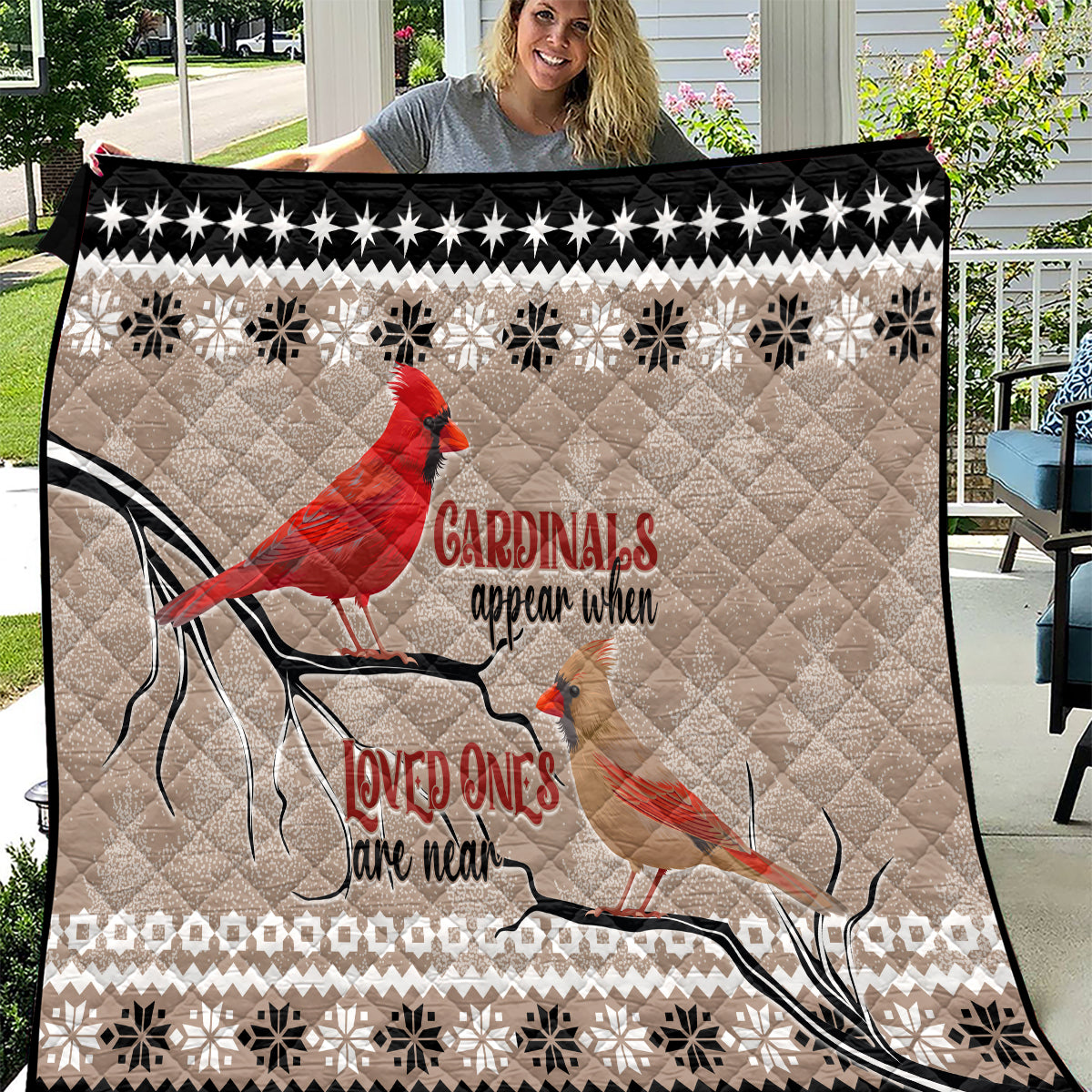 Beige and black cardinal birds quilt with red birds, snowflake pattern, star border