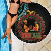 Round black Kwanzaa mandala beach blanket with white fringe, draped beside swimming pool