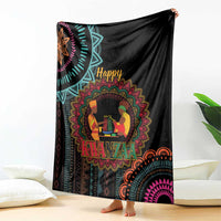 Black Kwanzaa mandala blanket with “Happy Kwanzaa” text and seated figures, on floor