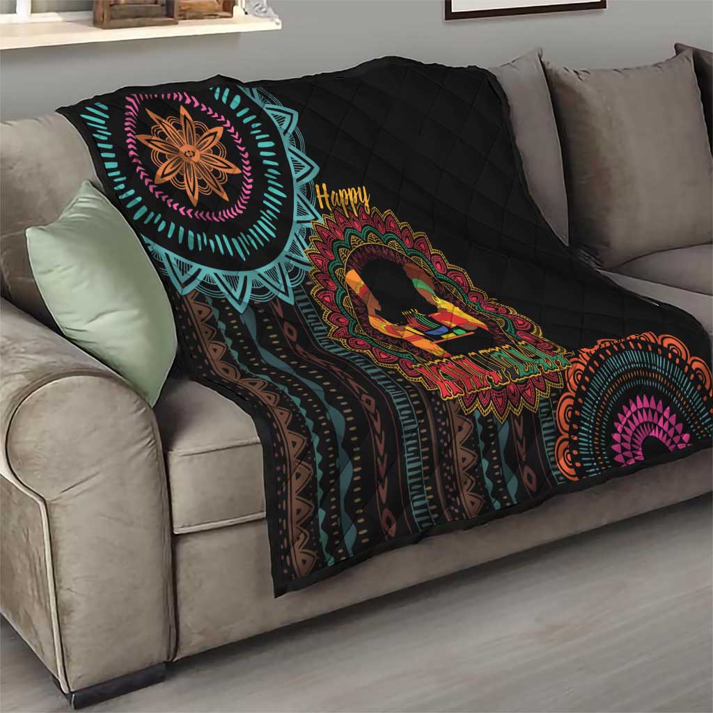 Black quilt on couch with turquoise pattern trim, “Happy Kwanzaa” center medallion