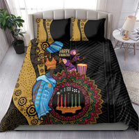Black African Kwanzaa bedding set on bed with two yellow patterned accent pillows