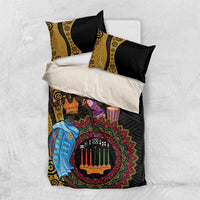 Black and yellow African Kwanzaa bedding set laid flat with matching pillow covers