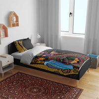 Black African Kwanzaa bedding set on bed with patterned pillows in a bedroom setting
