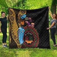 African quilt hanging outdoors: black backing, yellow swirl panel, colorful dancers and candles