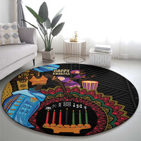 Black round carpet with colorful tribal design, central candle row, and “Happy Kwanzaa” text