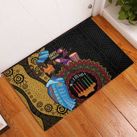 Black rubber doormat with tribal Kwanzaa dancers, mandala border, and candle motif