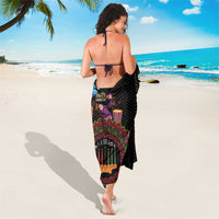 Black African sarong worn long, featuring back tie and colorful circular motif