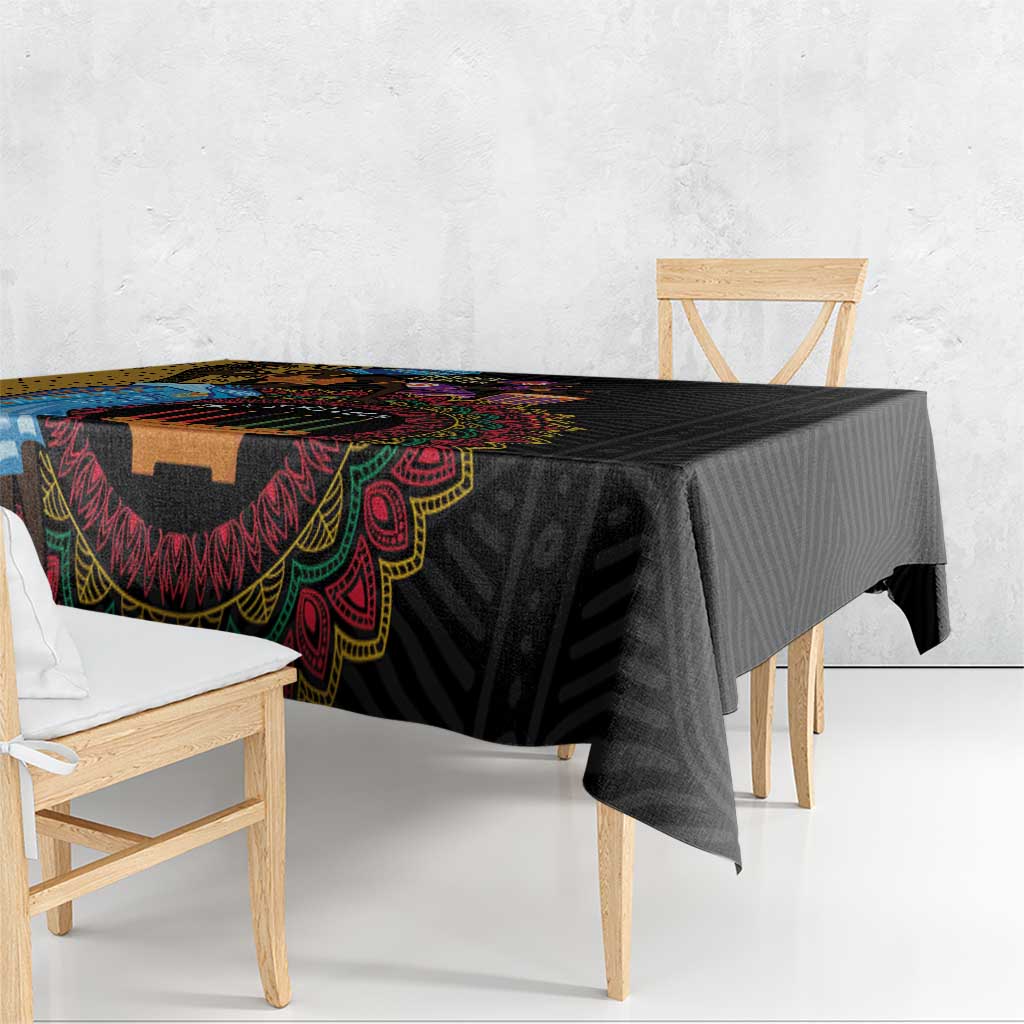 Black tablecloth with bold multicolor tribal motif along the edge