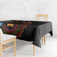 Black tablecloth with bold multicolor tribal motif along the edge