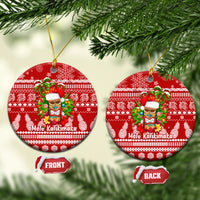 Red round ceramic Christmas ornament with Mele Kalikimaka tiki design and gold hanging loop