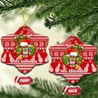 Red star-shaped ceramic Christmas ornament with Mele Kalikimaka tiki design and gold hanging loop