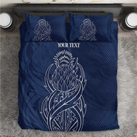Blue personalized duvet cover and pillow set with white thistle line art and text