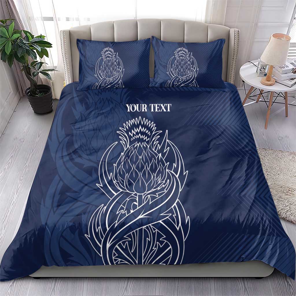 Blue personalized duvet cover with two matching pillows; white thistle line art and text