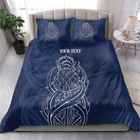 Blue personalized duvet cover with two matching pillows; white thistle line art and text
