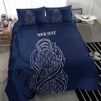 Blue personalized duvet cover with two pillows; white thistle-style line art and text