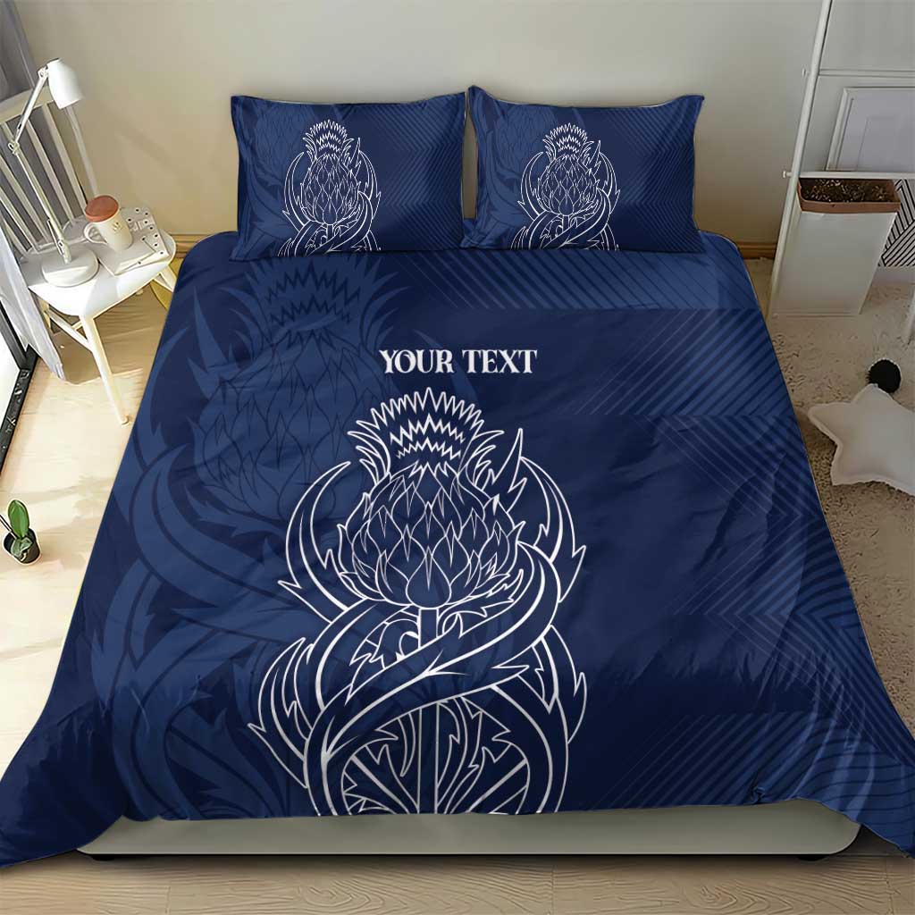 Blue personalized duvet cover and two pillows with white thistle line art and text
