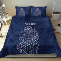 Blue personalized duvet cover and two pillows with white thistle line art and text
