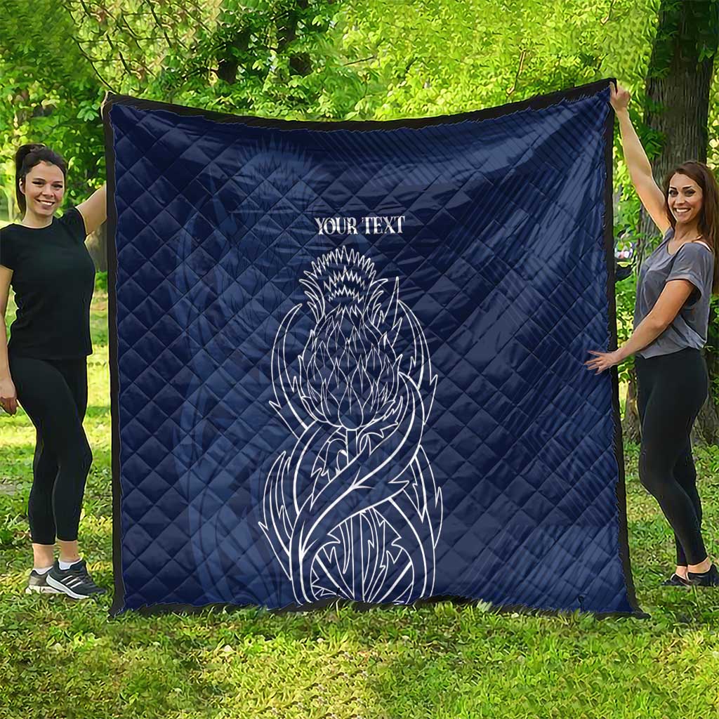 Blue quilt blanket with thistle line art and 'YOUR TEXT' display