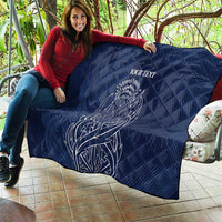 Blue quilt blanket with thistle line art and 'YOUR TEXT' spread out