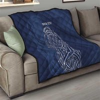 Blue quilt blanket with thistle line art and 'YOUR TEXT' on couch