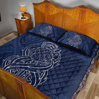 Blue quilt bed set on bed with thistle line-art quilt and two matching pillowcases
