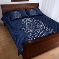 Blue quilt bed set with thistle line-art on quilt and two patterned pillowcases