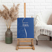 Blue canvas wall art on a wooden easel with “Italy Italiana” and “Your Text”
