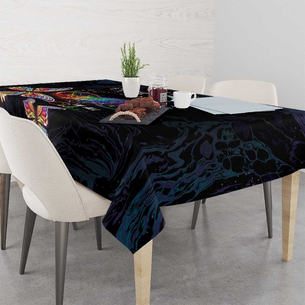 Dark navy tablecloth with colorful butterfly motifs, draped across the dining table