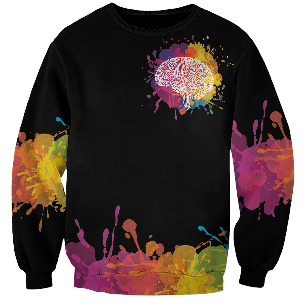 Black unisex sweatshirt with multicolor dandelion tree graphic and ink-splatter hem
