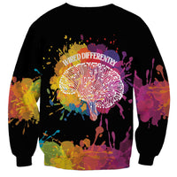 Black unisex sweatshirt with multicolor “wired differently” dandelion graphic and splatter